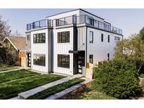 Modern two-story home with black trim windows, fresh lawn, and a rooftop deck at 1543 Glencoe St, Denver, CO 80220