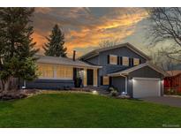 Charming two-story home featuring a landscaped front yard and attached two-car garage at 8370 E Princeton Ave, Denver, CO 80237