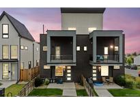 Modern home featuring a stylish brick facade, balconies, and well-maintained front yard with a privacy fence at 1302 N Stuart St, Denver, CO 80204