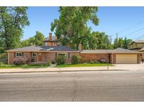 Charming brick home with mature trees, manicured landscaping, and a two-car garage offers delightful curb appeal at 3530 E 8Th Ave, Denver, CO 80206