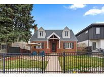 Charming brick home featuring a landscaped front yard with black iron fence, seating area, and inviting walkway at 35 S Albion St, Denver, CO 80246