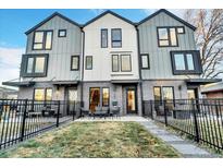 Modern townhome boasts a stylish gray and white facade, sleek windows, and a charming front patio with black metal fence at 1403 Yates St, Denver, CO 80204