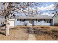 Charming blue single story home featuring a well-maintained front yard and attached garage at 3232 S Elm St, Denver, CO 80222