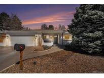 Charming single-story home featuring a well-manicured yard and an attached two-car garage at 9561 W Wesley Dr, Lakewood, CO 80227