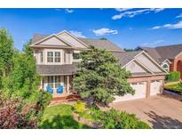 Charming two-story home with a well-maintained lawn, brick accents and a two car garage at 2742 S Braun Way, Lakewood, CO 80228