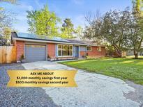 Charming red brick home with a well-manicured lawn and solar panels for energy savings at 2235 Edgewood Dr, Boulder, CO 80304