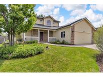 Well maintained two-story home with mature front yard, lush lawn and inviting curb appeal at 154 Falcon Cir, Mead, CO 80542