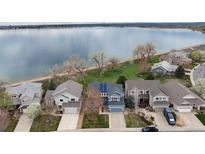 Stunning aerial view of lakeside homes boasting well-manicured lawns and waterfront access at 4814 S Upham Ct, Littleton, CO 80123