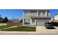 Charming two-story home with a well-maintained lawn and mature landscaping at 4614 Lyndenwood Cir, Highlands Ranch, CO 80130