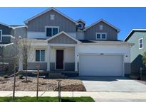 Charming two-story home featuring a two-car garage, landscaped front yard, and inviting covered porch at 1368 Orchard St, Brighton, CO 80601