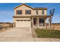 Charming two-story home featuring red shutters, stone accents, and a spacious two-car garage at 9935 Ceylon Ct, Commerce City, CO 80022