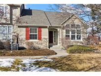 Attractive exterior of a two-story home with red shutters and stone accents at 6415 Trailhead Rd, Highlands Ranch, CO 80130