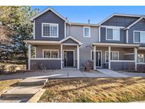 Charming townhome with inviting front porch and well-maintained landscaping at 19247 E Gunnison Pl # 104, Aurora, CO 80017