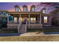 Charming home exterior with a welcoming front porch and stylish architectural details at sunset at 2730 Hanover N St, Denver, CO 80238