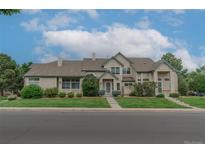 Charming two-story home with well-maintained landscaping and inviting curb appeal on a sunny day at 10087 E Hawaii Pl, Aurora, CO 80247