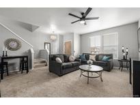 Bright living room featuring plush seating, a ceiling fan, and neutral decor, creating a cozy and inviting space at 9758 Laredo St # 37C, Commerce City, CO 80022