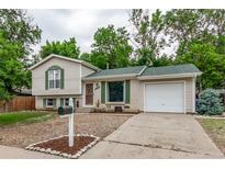 Charming single-Gathering home with a well-maintained front yard and attached one-car garage at 2212 S Naples Way, Aurora, CO 80013