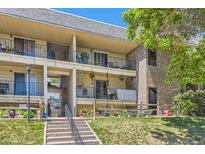 Inviting condo with balcony and outdoor space, enhanced by well-maintained landscaping and a cozy, welcoming facade at 4643 S Lowell Blvd # B, Denver, CO 80236