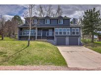 Beautiful two-story home with a two car garage and a well-manicured lawn at 8446 Lightening View Dr, Parker, CO 80134