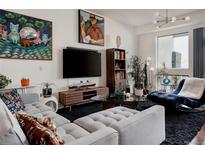 Bright living room showcasing unique furniture, stylish décor, and expansive windows at 2460 W 29Th Ave # 104, Denver, CO 80211