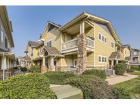 Inviting two-story townhome with charming stone accents and a private balcony at 9569 Pearl Cir # 204, Parker, CO 80134