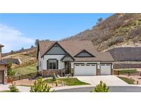 Charming two-story home features a three-car garage and beautifully landscaped front yard with mountain views at 2065 Sage Grouse Way, Castle Rock, CO 80109