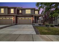 Charming home featuring a two-car garage and well-manicured lawn at twilight at 17848 Gallup St, Broomfield, CO 80023