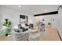 Bright living room featuring stylish furniture, modern decor, and an open floor plan at 1557 S Owens St # 59, Denver, CO 80232