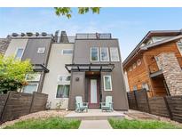 Modern home with a two-tone exterior, covered porch, and rooftop deck at 4557 Stuart St, Denver, CO 80212