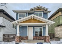 Two-story home with blue siding, brick accents, and a covered porch at 958 Superior Dr, Superior, CO 80027