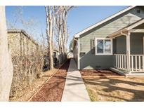Charming home with a cozy front porch and a walkway leading to the entrance at 3423 W Walsh Pl, Denver, CO 80219