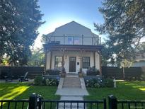 Charming two-story home featuring a delightful front porch and an upper level balcony at 1690 Spruce St, Denver, CO 80220