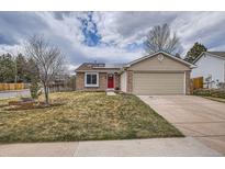 Charming single-story home featuring a brick facade, attached two-car garage, and a well-manicured front yard at 5587 S Simms Way, Littleton, CO 80127