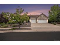 Charming single-story home featuring a well-manicured front yard and a spacious three-car garage at 5924 S Kittredge St, Centennial, CO 80016