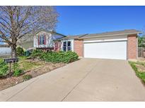 Charming single-Gathering home with a well-maintained lawn, brick accents, and an attached two-car garage at 1796 S Yampa Way, Aurora, CO 80017