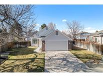Charming exterior with attached garage and well-maintained lawn and driveway at 4493 Dunkirk Way, Denver, CO 80249