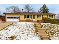 Charming brick home featuring a one car garage and a welcoming front porch at 1157 S Vivian St, Lakewood, CO 80228