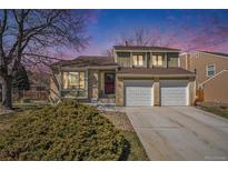 Inviting two-story home with a manicured front yard and a two-car garage at 7345 S Eagles Nest Cir, Littleton, CO 80127