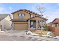 Charming two-story home featuring a two-car garage, covered front porch, and beautifully landscaped yard at 6731 Pinery Villa Pl, Parker, CO 80134