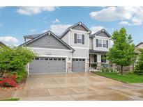 Charming two-story home with three-car garage, stone accents, and a well-manicured lawn on a sunny day at 6520 Empire Ave, Frederick, CO 80516