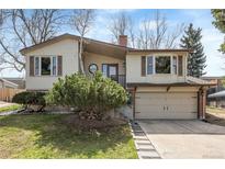 Charming home with a well-maintained front yard and attached two-car garage at 8210 W 72Nd Pl, Arvada, CO 80005