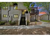 Condo exterior featuring stairs to front door, balcony, stone landscaping, and well-maintained surroundings at 4903 W 73Rd Ave, Westminster, CO 80030