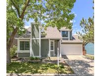 Charming two-story home with a well-maintained lawn and a two-car garage at 944 E Lily Ct, Highlands Ranch, CO 80126