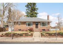 Charming brick home with a well-manicured front yard and classic architectural details at 4121 W 49Th Ave, Denver, CO 80212