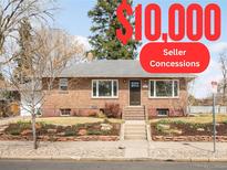 Charming single-story brick home with well-maintained front yard and mature trees on a sunny day at 4121 W 49Th Ave, Denver, CO 80212