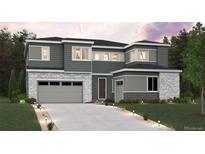 Two-story home with gray siding, stone accents, and a two-car garage at 1714 Morgan Dr, Erie, CO 80516