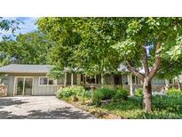 Charming single-story home with lush, mature landscaping and a welcoming front porch at 1315 Tipperary St, Boulder, CO 80303