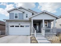 Charming two-story home with stone accents, inviting front porch, and a two-car garage at 8073 Mt Lincoln Rd, Littleton, CO 80125