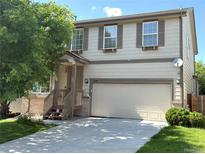 Charming two-story home with neutral siding, attached two-car garage, and well-manicured front lawn at 20401 E Chenango Pl, Aurora, CO 80015