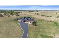 Expansive aerial view showcases this amazing home's setting and beautiful lawn at 575 Howling Cir, Elizabeth, CO 80107